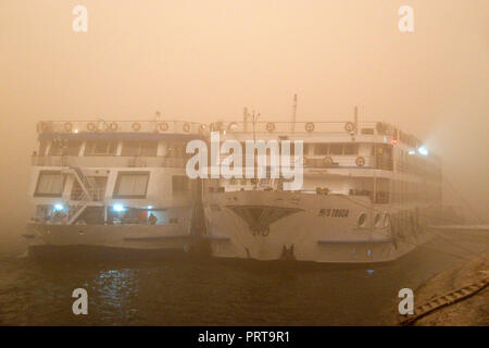 Nil Kreuzfahrten auf dem Nil bei einem abendlichen Sandsturm in Qena, Ägypten günstig. Stockfoto