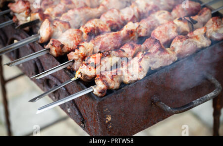 Kochen im Freien Schweinefilet Schaschlik oder shashlyk, ein Teller aufgespießt und gegrillt Cubes von Fleisch Stockfoto