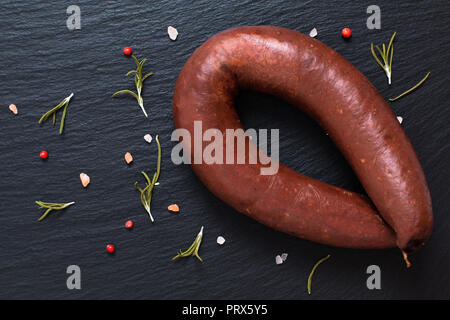 Essen Konzept rohe Blutwurst schwarze Würste auf schwarzem Schiefer Stockfoto