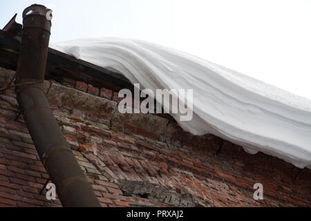 St. Petersburg, Russland; - am 5. Januar 2011: riesiger Haufen Schnee ist aus einem alten Gebäude Dach zu fallen Stockfoto