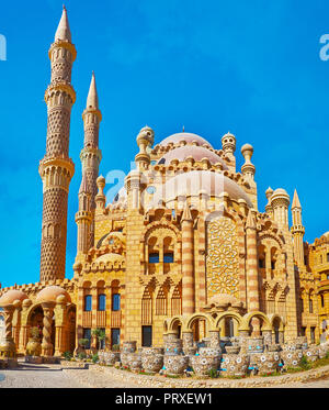 Der Brunnen, geformt wie Schüsseln und Töpfe, geschmückt mit Blumen, gelegen neben der Wand von Al Mustafa (Al-Sahaba) Moschee in Sharm El Sheikh, Egyp Stockfoto