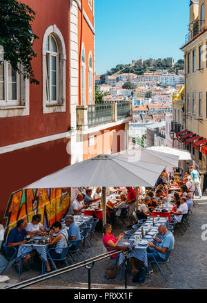 Lissabon, Portugal - Okt 3, 2018: Outdoor Cafe auf der alten Gassen der Alfama, Lissabon mit Blick auf das Castelo Sao Jorge und Baixa Stockfoto