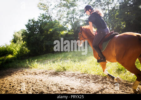 Porträt der jungen Frau Reiten in der Landschaft Stockfoto