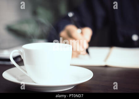 Close up Tasse Kaffee auf Manager oder Business Mann unterzeichnen Vertrag Hintergrund, Rechtsanwalt schriftlich auf Papier Konzept Stockfoto