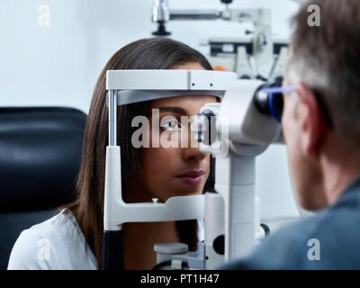 Optiker Prüfung der jungen Frau Auge Stockfoto