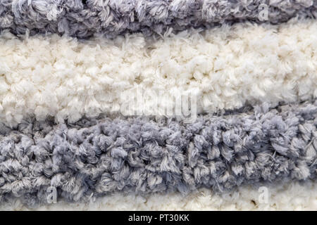 Hintergrund der weißen und grauen Weichen textilen Fringe Stockfoto