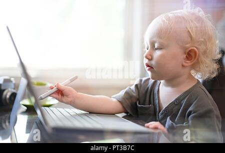 Baby spielt mit Laptop-computer Stockfoto