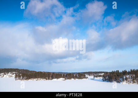 Gefrorene Saimaa See bei bewölktem Himmel. Ländliche Winterlandschaft, Finnland Stockfoto