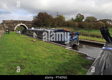 Nach den jüngsten Regenfällen Teil der Leeds und Liverpool canal öffnet, ein Boot arbeitet bis die Schleusen bei Johnsons Hill in der Nähe von Chorley, Lancashire. Stockfoto