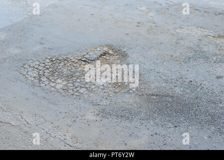 Große Grube mit Steinen auf dem Asphalt Autobahn Stockfoto