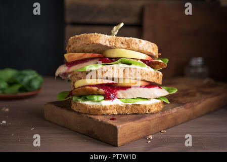 Truthahn oder Hähnchen übrig gebliebene Sandwich mit Füllung und Preiselbeersoße. Frisch von Thanksgiving oder Weihnachten Türkei Reste auf knusprigem wholemea gemacht Stockfoto