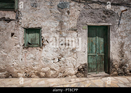 Altes Haus mit hölzernen Tür und verwitterte Fassade in ländlichen Dorf Stockfoto