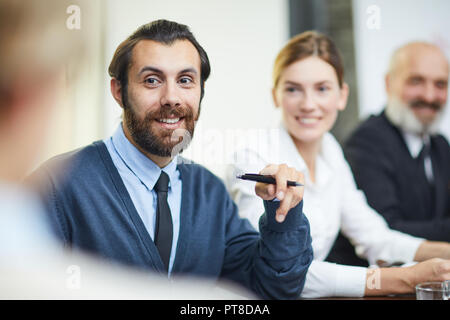 Junge Bartgeier Geschäftsmann oder Delegierte im Gespräch mit einem Kollegen an der Konferenz oder Seminar Stockfoto