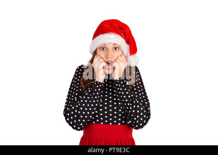 Angst Frau schaut nervös, beißen Fingernägel und Vor etwas Angst. emotionale Mädchen in Santa Claus Weihnachten Hut auf weißem Hintergrund. ho Stockfoto