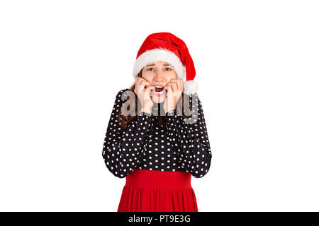 Nervöse angst Frau mit traurigen Ausdruck, zusammengebissene Zähne, erfährt über das tragische Ereignis. emotionale Mädchen in Santa Claus Weihnachten Hut isoliert Stockfoto