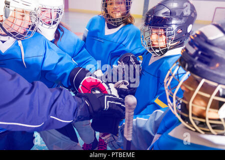 - Nahaufnahme Portrait von Happy Teenager Jungs und Mädchen, Eishockey Spieler die Hände zusammen Stockfoto