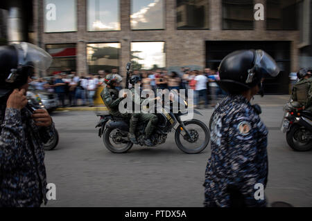 08. Oktober 2018, Venezuela, Caracas: Soldaten vorbei das Gefängnis der Geheimpolizei Sebin, nach einem inhaftierten oppositionellen Stadtrat Unter unklaren Umständen auf dem Gelände der Institution enthalten. Nach Angaben der Regierung, der Rat der Stadt sprang aus einem Fenster auf dem 10. Stock. Aber seine Partei denkt, dass er getötet wurde. Foto: Rayner Pena/dpa Stockfoto