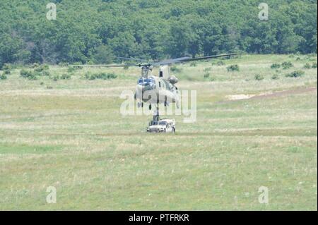 Soldaten aus der 1-376 Aviation Battalion der Nebraska Army National Guard verhalten Schlinge last Ausbildung bei der Dachs Drop Zone am Fort McCoy, Wis., 20. Juli 2017. Die Schulung an einem Humvee zu einem Chinook Hubschrauber, die dann durch die Luft transportiert wurde. Stockfoto