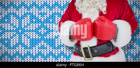 Zusammengesetztes Bild des Innenfeldes von Santa mit Boxhandschuhen Stockfoto