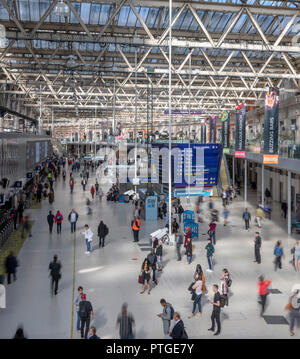 Blurry Passagiere für ihre Züge im Bahnhof Waterloo Station in London warten. Alle Schuß von der Balkon über der Bahnhofshalle. Stockfoto