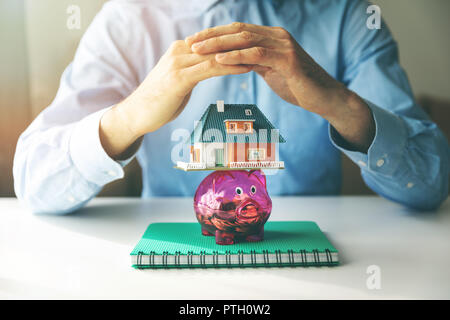 Gehäuse Einsparungen, Hypotheken und Versicherungen Konzept Stockfoto
