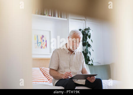 Ältere Menschen mit digitalen Tablet auf dem Bett Stockfoto