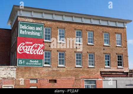 JOHNSON CITY, TN, USA -9/30/18: Eine aktualisierte Version eines alten Coca-cola Schild ist auf der Seite von einem alten Backsteingebäude in der Innenstadt von angezeigt. Stockfoto