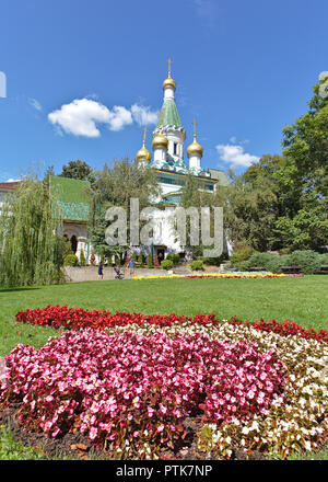 Ansicht der Russischen Kirche mit rosa Blume Garten im Vordergrund. Stockfoto