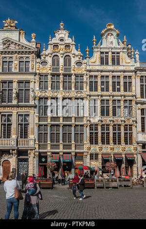 Brüssel, Belgien - 26. September 2018: Drei braun Steinfassaden mit goldenen Verzierungen und Statuen auf der Grand Place gegen den blauen Himmel. Menschen zu Fuß Stockfoto