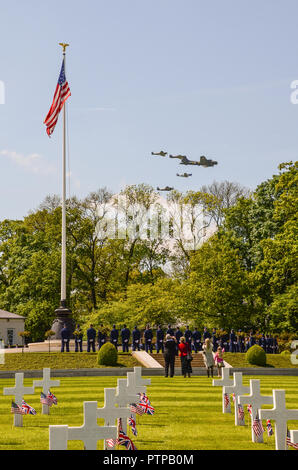 B-17 Flying Fortress Sally B und Kampfflugzeuge durchgeführt ein commemorative Flypast über die Cambridge amerikanischen Friedhof und Denkmal US Flag, Kreuze Stockfoto