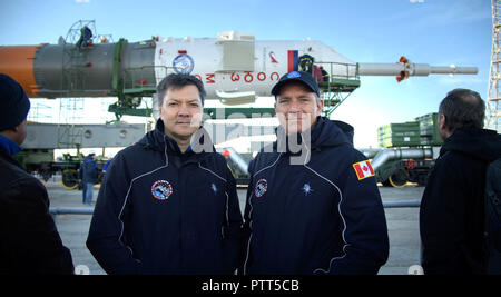 Baikonur, Kasachstan. 10. Oktober, 2018. Expedition 57 Backup crewmember Oleg Kononenko von Roskosmos, Links, und David Saint Jacques der Kanadischen Raumfahrtagentur darstellen, da die Sojus MS-10 Raumschiff, mit dem Zug zur Startrampe gerollt in Vorbereitung für den Start auf dem Kosmodrom Baikonur Oktober 9, 2018 in Baikonur, Kasachstan. Internationale Raumstation ISS Expedition 57 crew Nick Haag der NASA und Alexey Ovchinin von roskosmos sollen am 11. Oktober an den Start gehen und verbringen die nächsten sechs Monate Leben und Arbeiten an Bord der Internationalen Raumstation. Credit: Planetpix/Alamy Stockfoto