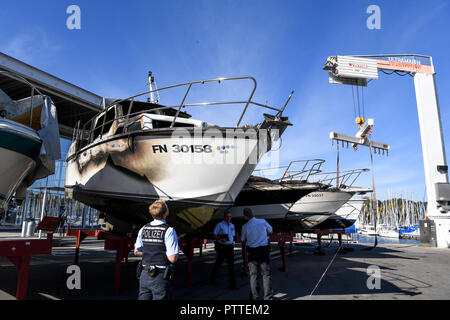 11 Oktober 2018, Baden-Wuerttemberg, Kressbronn: Polizisten Blick auf mehrere Motor Yachten, gebrannt und wurden an Land gebracht. Foto: Felix Kästle/dpa Stockfoto