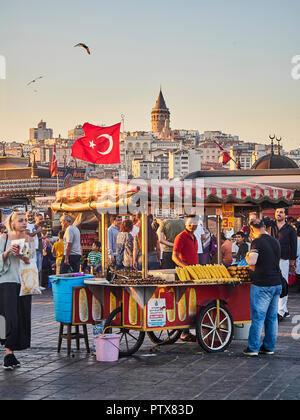 Istanbul, Türkei - 7. Juli 2018. Maiskolben in einer Straße von Eminönü, ein ehemaliger Bezirk von Istanbul, Türkei ausgeht, mit der Galata Turm im backgroun Stockfoto