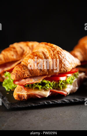 Klassische BLT croissant Sandwiches auf dunklem Hintergrund Stockfoto