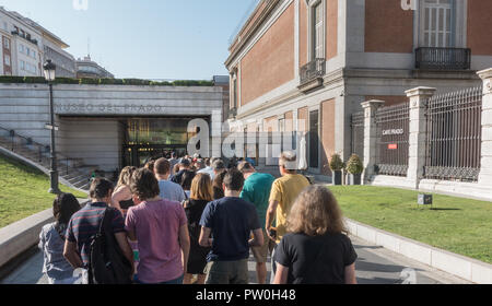 Touristen mit zeitgesteuerter Tickets warten auf Eingang zu beliebten Prado Museum in Madrid, Spanien. Siehe Museo del Prado Zeichen auf Gebäude. Stockfoto