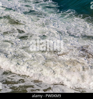 High-Angle-Aufnahme von rauschendem Meer / Wellen brechen und zerstreuen. Stockfoto