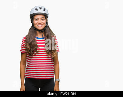 Junge arabische Radfahrer Frau tragen Schutzhelm über isolierte Hintergrund mit einem glücklichen und kühlen Lächeln auf dem Gesicht. Glückliche Person. Stockfoto