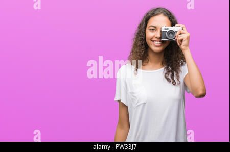 Junge Hispanic Frau Aufnahme von Bildern mit Vintage Kamera mit einem glücklichen Gesicht stehen und lächelnd mit einem selbstbewussten lächeln zähne Stockfoto