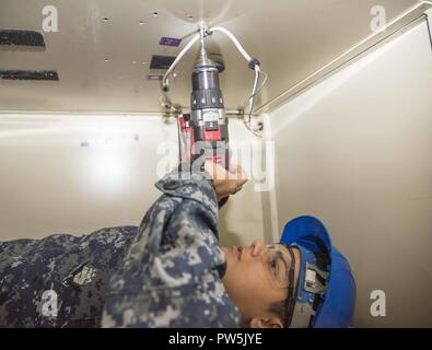 PORTSMOUTH, Virginia (Sept. 20, 2017) der Luftfahrt Bootsmann Mate (Ausrüstung) Airman Willmarie Vazquez Roldan, aus Aguadilla, Puerto Rico, dissembles ein Rack an Bord der Flugzeugträger USS Dwight D. Eisenhower (CVN 69) (IKE). Ike ist zurzeit eine geplante schrittweise Verfügbarkeit (PIA) im Norfolk Naval Shipyard während der Erhaltungsphase der optimiert Flotte Notfallplan (OFRP). Stockfoto