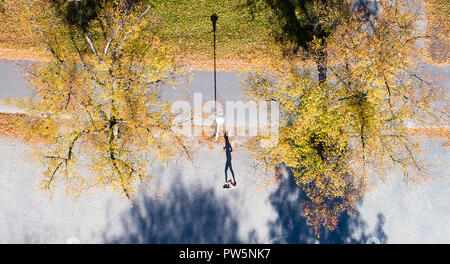 Hannover, Niedersachsen. 12 Okt, 2018. 12. Oktober 2018, Deutschland, Hannover: Ein Jogger wirft einen Schatten auf der Löwe Bastion am Maschsee inmitten autumnally verfärbten Bäumen. (Luftbild mit Drone) Credit: Julian Stratenschulte/dpa/Alamy leben Nachrichten Stockfoto