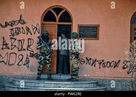 Srinagar, Kashmir. 13. Oktober 2018. Ein Mann geht zu einem Wahllokal in der dritten Phase der Kommunalwahlen in SrinagarKashmir zu stimmen. Die dritte Phase des Jammu und Kaschmir städtischen lokalen Körper begann in 300 Wahllokalen bei 6 am Samstag unter strengen Sicherheitsmaßnahmen bin. Mehr als 365 Kandidaten sind in den Kampf für die Wahlen. Credit: SOPA Images Limited/Alamy leben Nachrichten Stockfoto