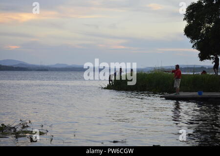 Caroni Fluss, Venezuela. Oktober 12, 2018. Sonnenuntergang an den Ufern des imposanten South American River, eine Gruppe von Menschen, die Fisch am Ufer des Flusses Caroni in der Dämmerung dieses klaren Tag. Credits: Jorgeprz/Alamy Leben Nachrichten. Stockfoto