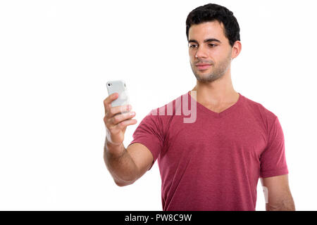 Studio shot von jungen hübschen Hispanic mit Handy Mann Stockfoto