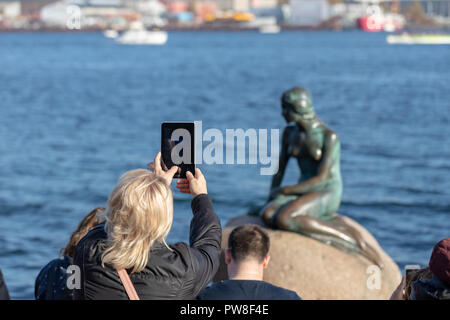 Frau ein Foto der Kleinen Meerjungfrau mit eine kleine Tablette, Kopenhagen, Dänemark Stockfoto