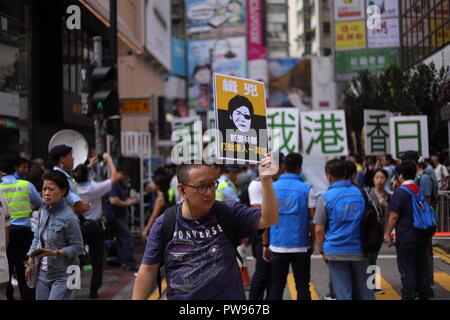 Hongkong, China. 14 Okt, 2018. Ein Mann Anzeige ein Banner mit caricaturaized Bild der Chief Executive der SAR HONGKONG, Carrie Lam. 1000 die Bürger von Hongkong marschierten heute HKSARs Osten Lantau Metropolis Projekt, ein mega Projekt, Schätzung würde 600 Milliarden HK Dollar über eine 2.200 Hektar Land Reclamation zu verbringen, zu protestieren. Das Banner in der chinesischen wollte liest, BANDIT CARRIE LAM. Okt-14, 2018 Hong Kong. ZUMA/Liau Chung-ren Credit: Liau Chung-ren/ZUMA Draht/Alamy leben Nachrichten Stockfoto