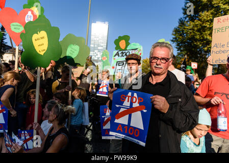 Berlin, Berlin, Deutschland. 14 Okt, 2018. Eine Demonstrantin gesehen hält ein Plakat trägt Stop 100 Während des Protestes geschrieben. Protest gegen die geplante Autobahn A100, rund 60 Personen der Kreuzung am Elsenstra Park S-Bahn Station blockiert. Quelle: Markus Heine/SOPA Images/ZUMA Draht/Alamy leben Nachrichten Stockfoto