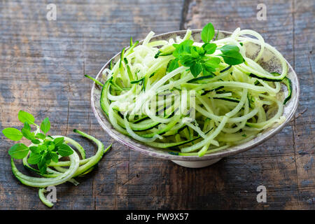 Zucchini Spaghetti - zerfetzt, Zucchini in eine Schüssel geben. Stockfoto