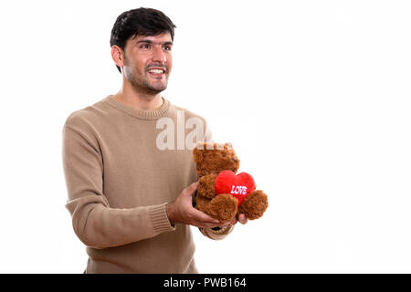 Nachdenklich glücklich Persischen Mann lächelnd, während sie Teddybär wit Stockfoto