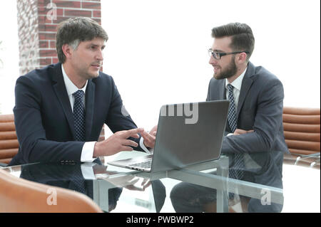 Zwei Geschäftsleute über Aufgaben im Büro sitzen. Stockfoto