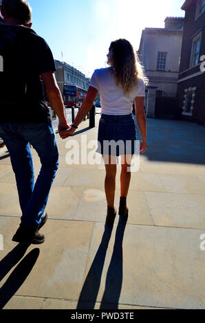Junges Paar Hand in Hand in Whitehall, London, England, UK. Mit Hintergrundbeleuchtung Stockfoto